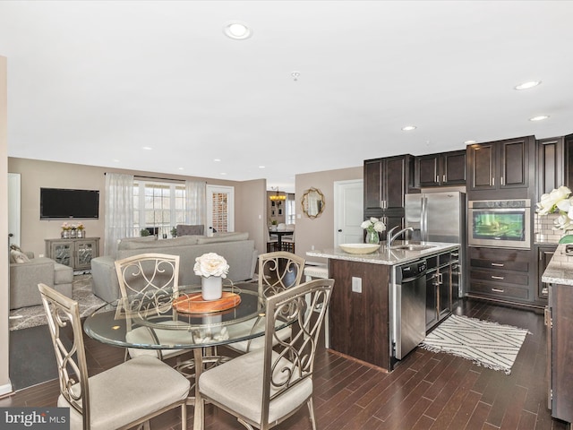 dining room with dark wood finished floors and recessed lighting