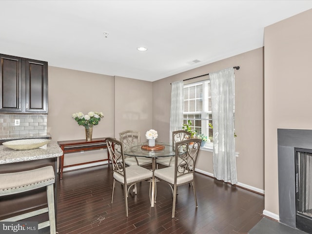 dining space featuring recessed lighting, baseboards, dark wood-type flooring, and beverage cooler