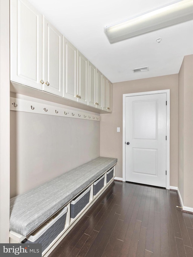 mudroom with visible vents, baseboards, and dark wood-style flooring