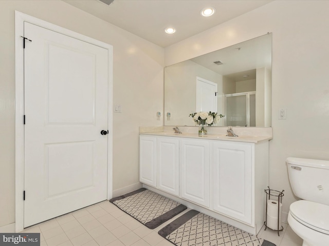 full bath featuring a shower stall, toilet, double vanity, recessed lighting, and a sink