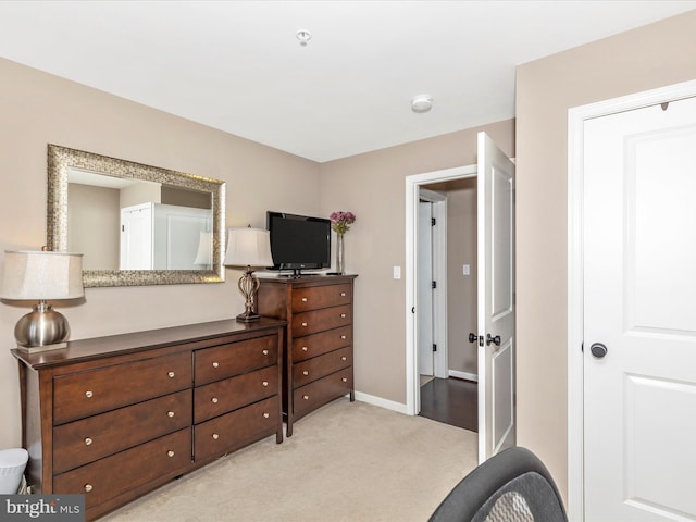 workout area with light colored carpet and baseboards