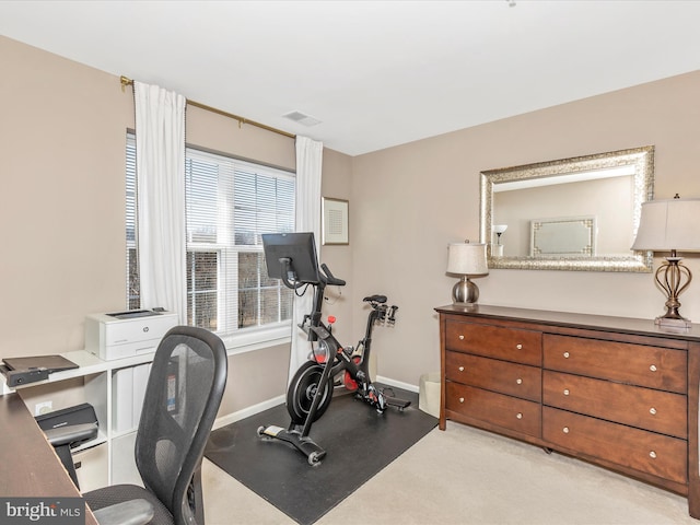 exercise room with visible vents and baseboards