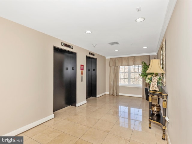 interior space with elevator, baseboards, and visible vents