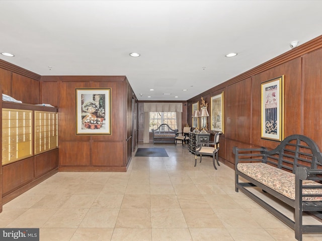 corridor featuring recessed lighting, mail area, wood walls, and ornamental molding