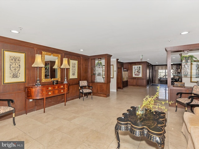 interior space featuring recessed lighting, wood walls, and ornamental molding