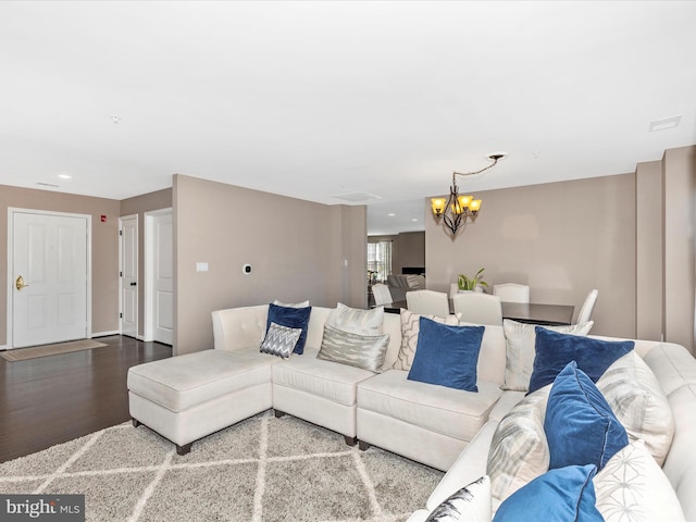 living area with recessed lighting, an inviting chandelier, and wood finished floors