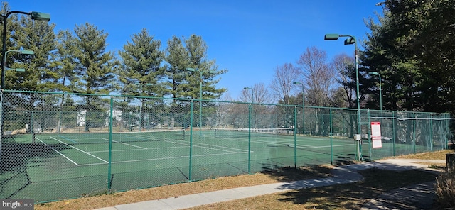 view of tennis court featuring fence