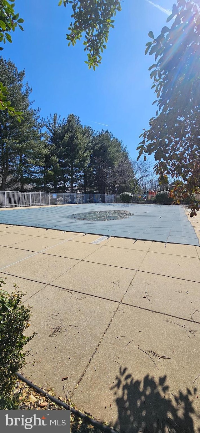 view of swimming pool featuring fence