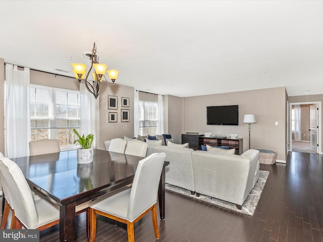 dining room with a notable chandelier, baseboards, and dark wood-style flooring