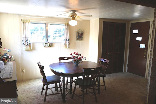 dining space with carpet and ceiling fan