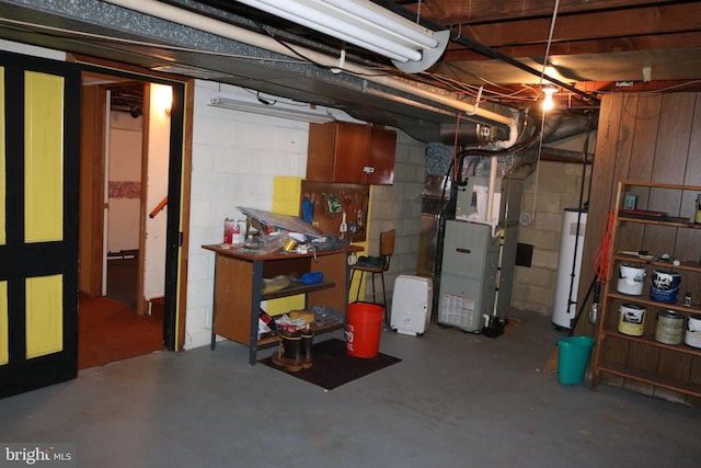 unfinished basement with gas water heater and heating unit