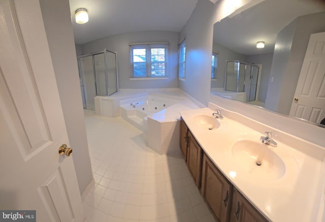 bathroom with a stall shower, a sink, a tub with jets, and double vanity