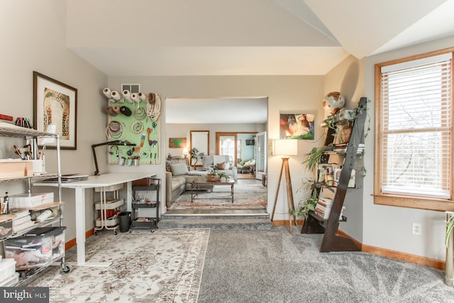 entryway with vaulted ceiling, baseboards, and carpet floors