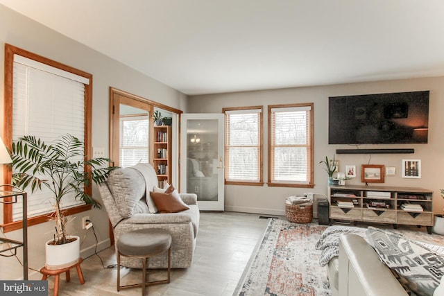 sitting room featuring baseboards and wood finished floors