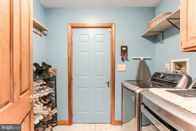 clothes washing area with cabinet space and washing machine and dryer