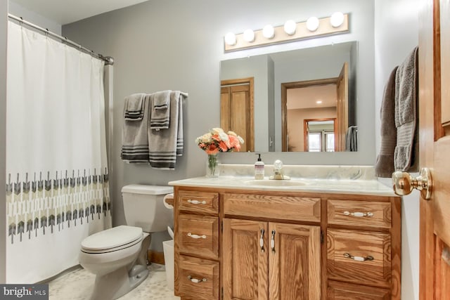 bathroom with vanity, curtained shower, toilet, and tile patterned flooring