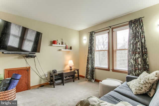 living area with baseboards and carpet