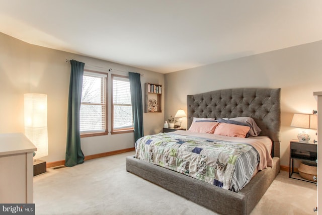 bedroom featuring baseboards and carpet