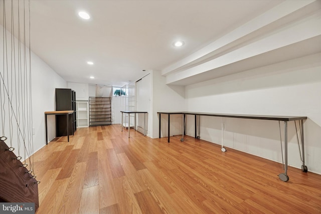 basement with light wood-style flooring and recessed lighting