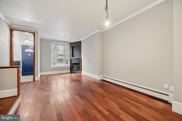 unfurnished living room with baseboards, wood-type flooring, crown molding, a fireplace, and a baseboard heating unit