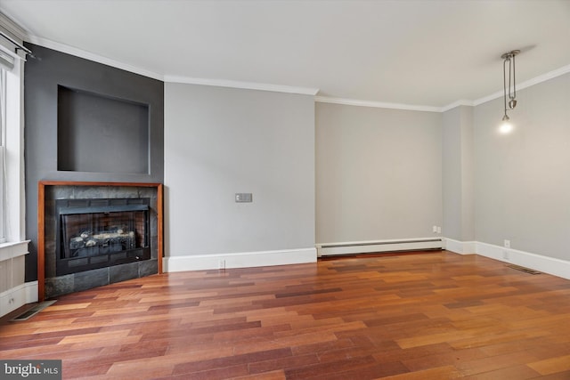 unfurnished living room with visible vents, a tile fireplace, wood finished floors, baseboard heating, and crown molding