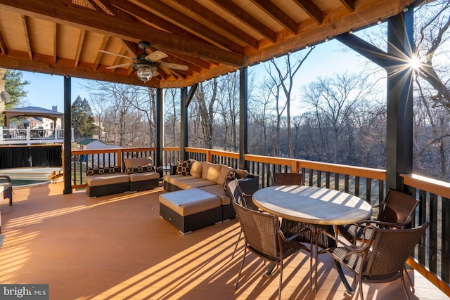 deck featuring an outdoor living space, ceiling fan, and outdoor dining space