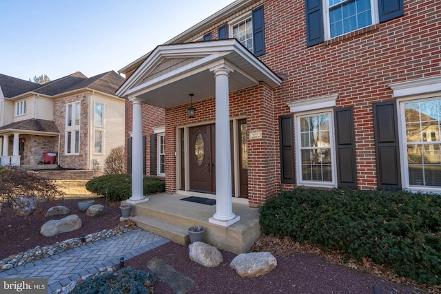 property entrance with brick siding