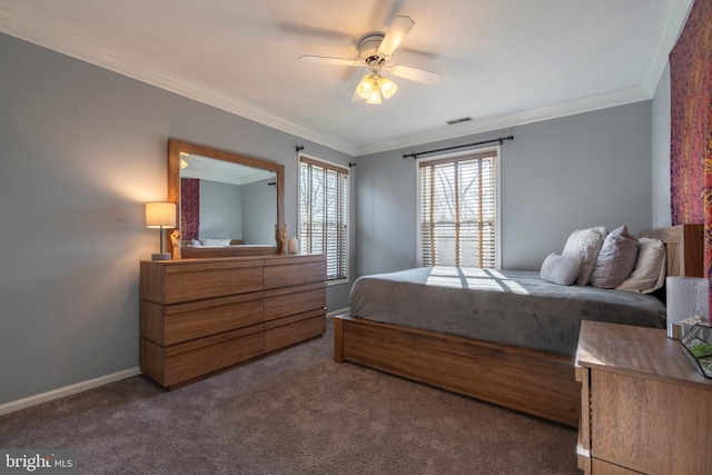 carpeted bedroom featuring visible vents, baseboards, a ceiling fan, and crown molding