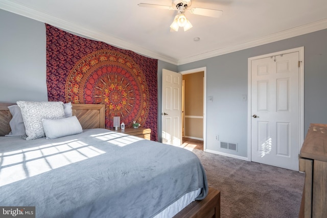 carpeted bedroom featuring visible vents, baseboards, ceiling fan, and crown molding