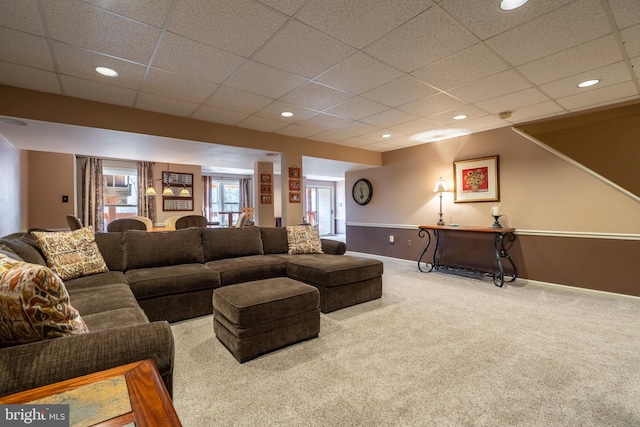 living area featuring recessed lighting, a healthy amount of sunlight, baseboards, and carpet