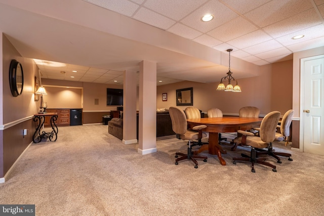 carpeted dining area featuring recessed lighting, a paneled ceiling, and baseboards