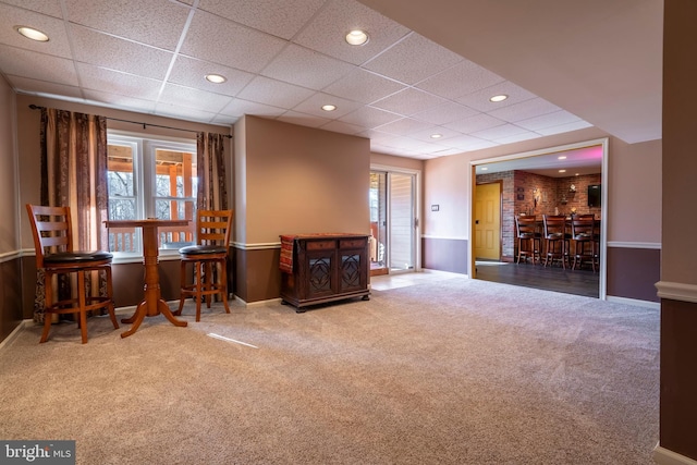 sitting room with a wealth of natural light, recessed lighting, a dry bar, and carpet floors