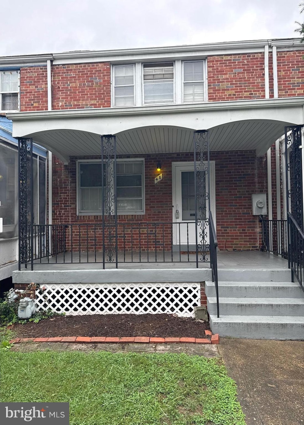 view of front facade featuring a porch and brick siding