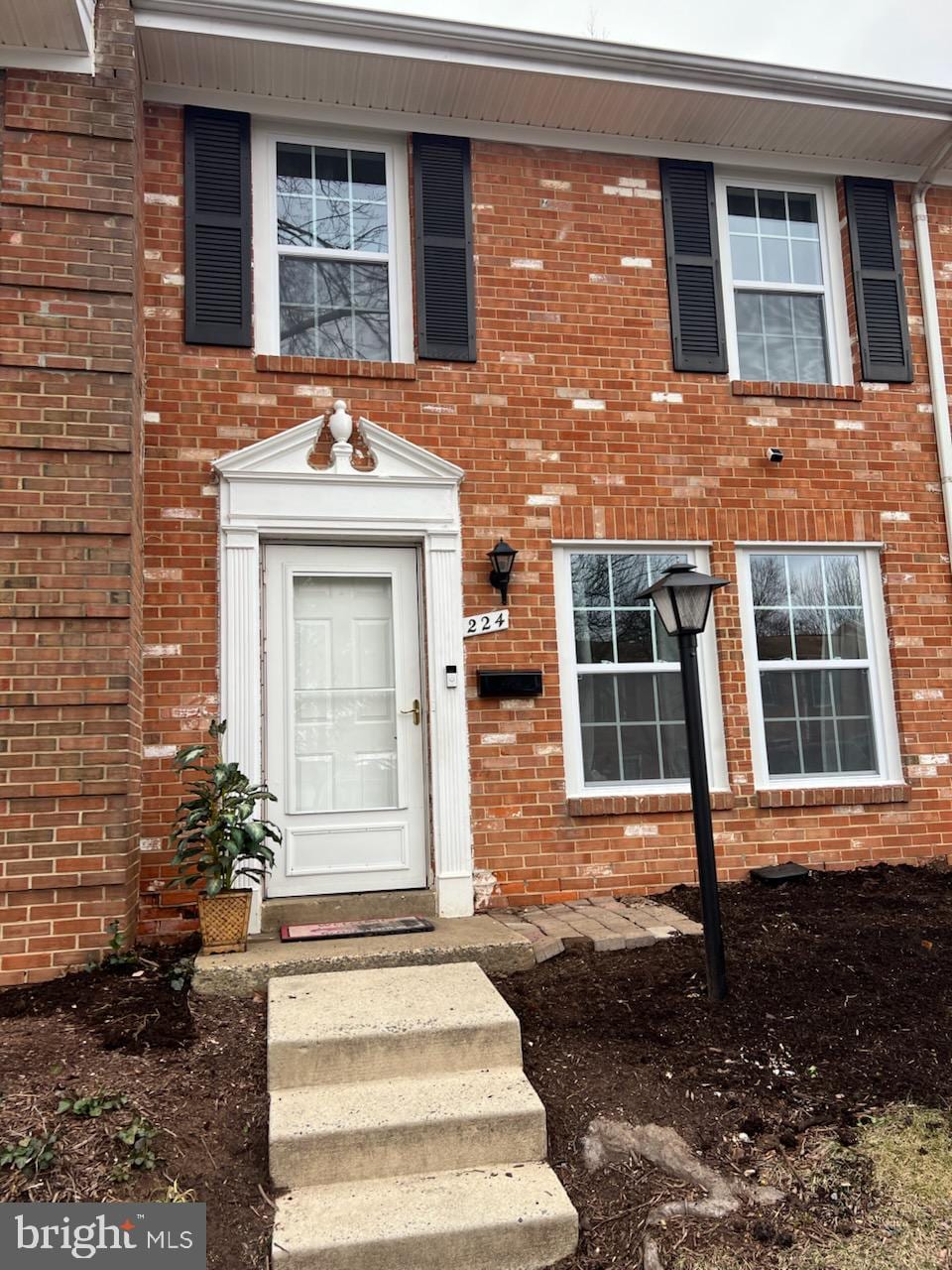 property entrance featuring brick siding