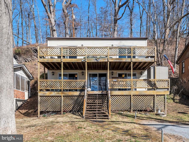 rear view of house featuring a wooden deck