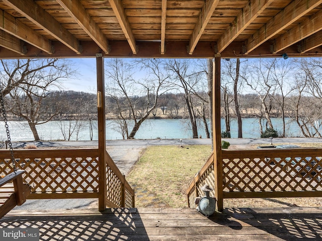 wooden terrace featuring a water view