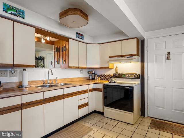 kitchen featuring light countertops, electric range, under cabinet range hood, and a sink