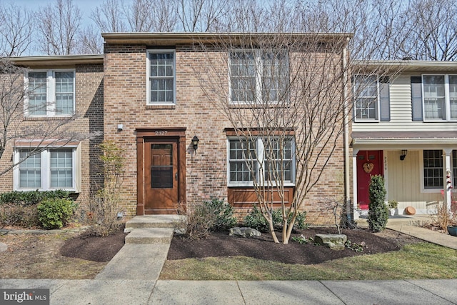 townhome / multi-family property featuring brick siding