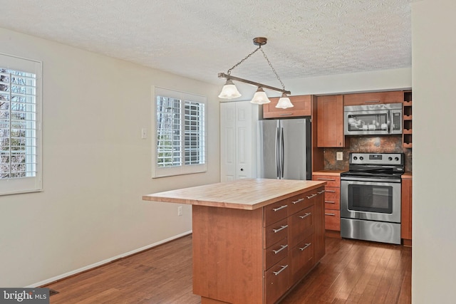 kitchen featuring stainless steel appliances, butcher block countertops, dark wood-type flooring, and tasteful backsplash