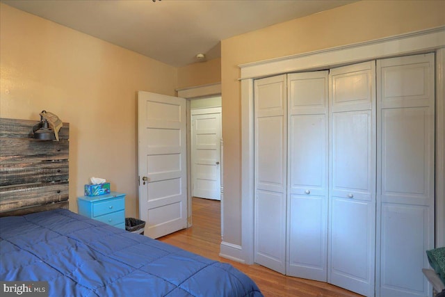 bedroom featuring a closet and light wood-style flooring