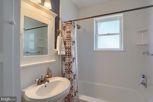 bathroom featuring shower / tub combo and a sink