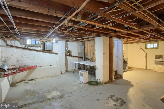 basement featuring stairs and electric panel