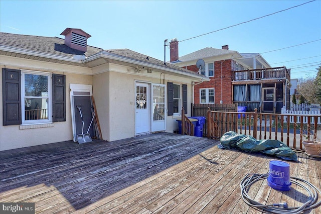 wooden terrace featuring fence