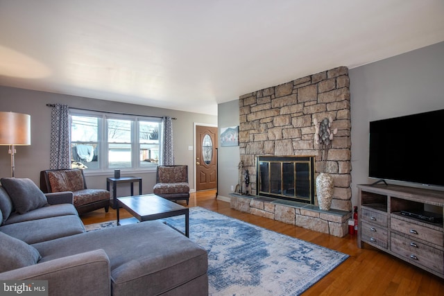 living room with a fireplace and wood finished floors