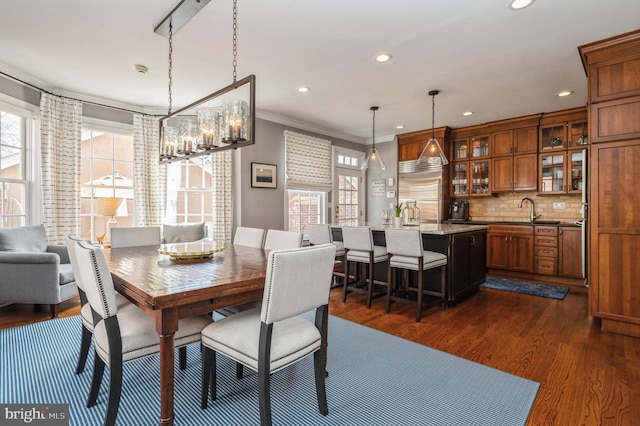 dining area with crown molding, dark wood-type flooring, recessed lighting, and a healthy amount of sunlight