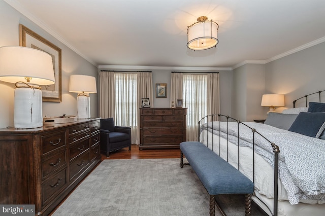 bedroom featuring wood finished floors and crown molding