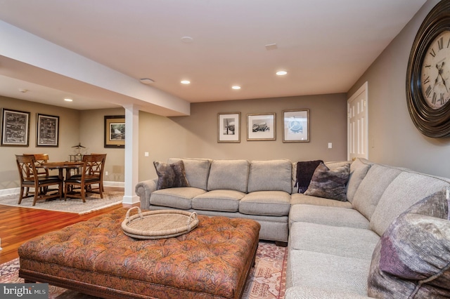 living room featuring baseboards, wood finished floors, and recessed lighting