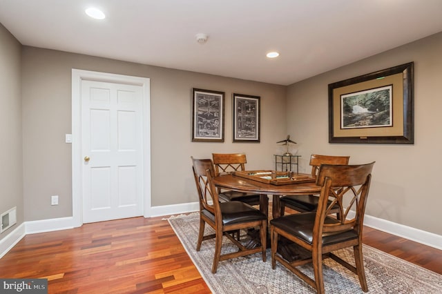 dining area with recessed lighting, visible vents, baseboards, and wood finished floors