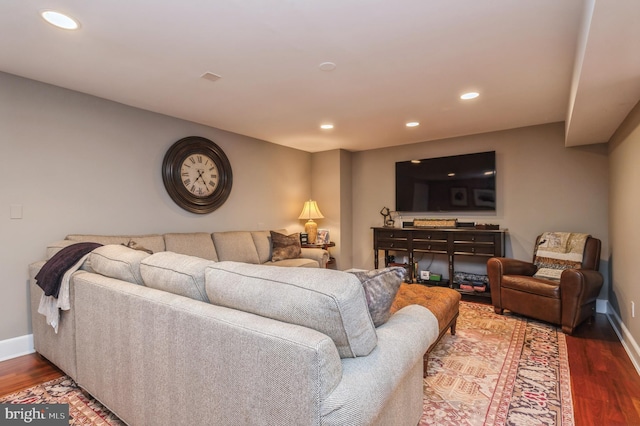 living room featuring baseboards, wood finished floors, and recessed lighting