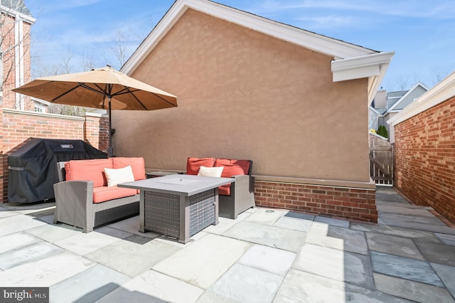 view of patio with area for grilling and fence